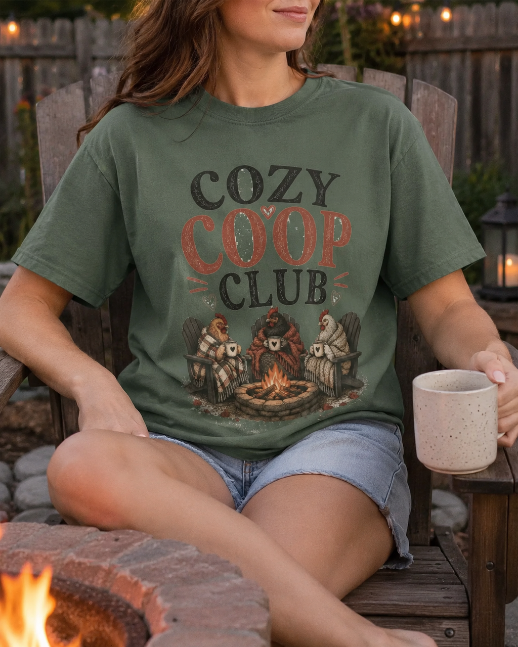 Cozy Coop Club fall chicken tee, worn by a fire pit at dusk